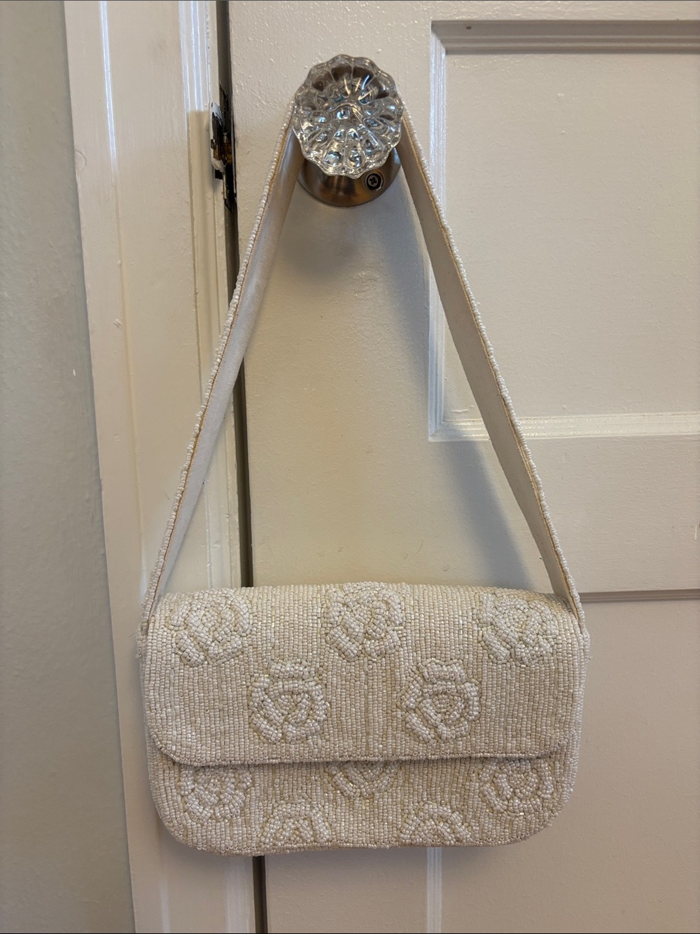 Ivory rosette beaded shoulder bag